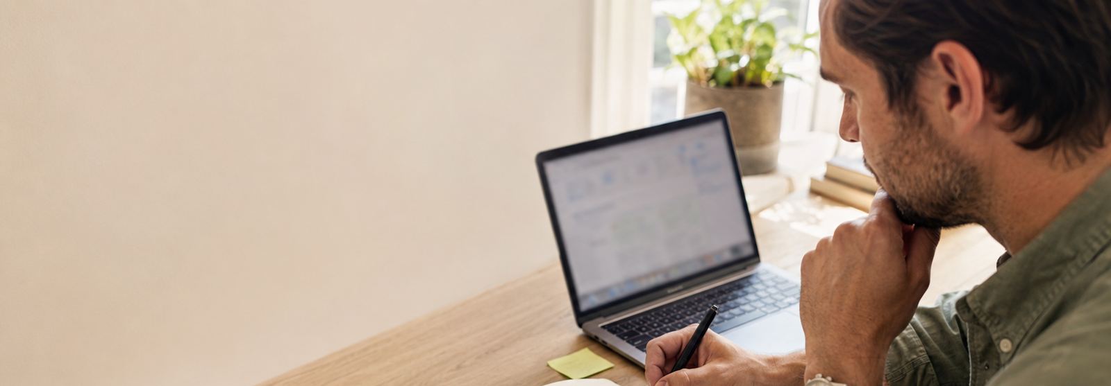 Working through notes beside a laptop